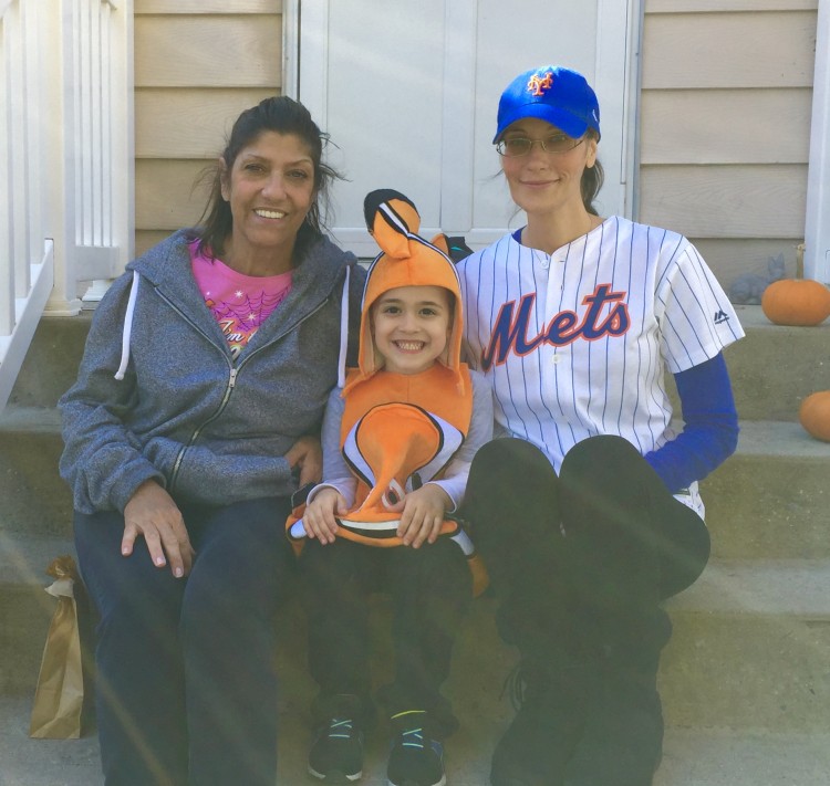 Nicole's mother, her son, and Nicole in a baseball cap.