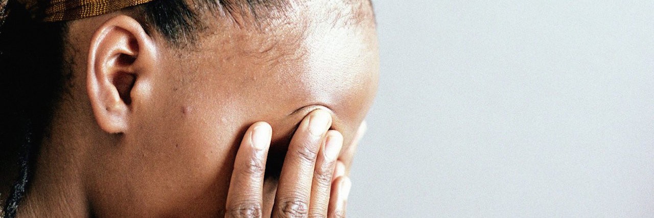 Childhood Anxiety Resurfaces in an Adult Woman with her head in her hands