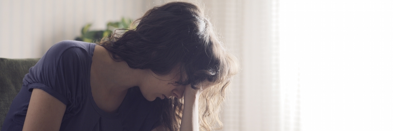 When Guilt Becomes Your Primary Diagnosis Depressed young woman sitting in chair at home