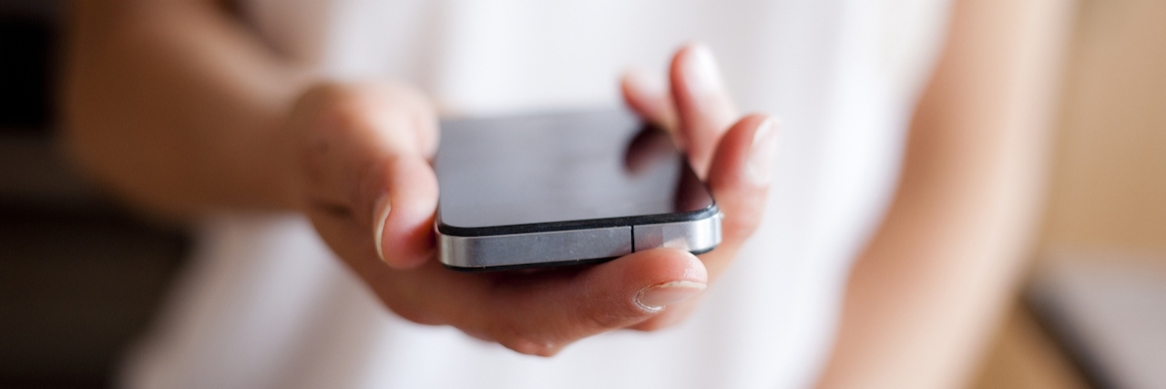 Phone Call From Brother Saves Woman With Bipolar Disorder's Life Close up of young woman handing phone