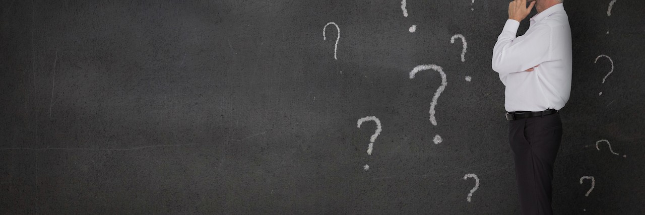 Questions I Had About My Autism Spectrum Disorder man looking at wall of question marks