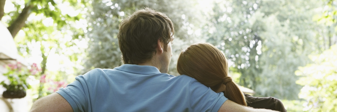 Letter to Future Partner From Woman With Ankylosing Spondylitis Couple on bench, woman resting head on man's shoulder, rear view