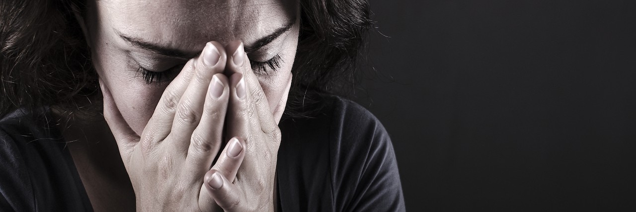 What Anxiety Taught Me Depressed woman with hands over her face.