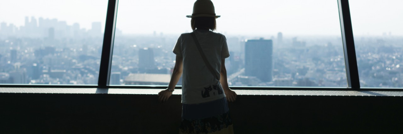 Woman watching Tokyo cityscape from high rise