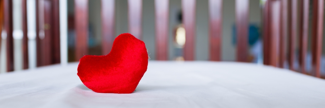 Facing Rheumatoid Arthritis While Pregnant Heart in baby's crib.