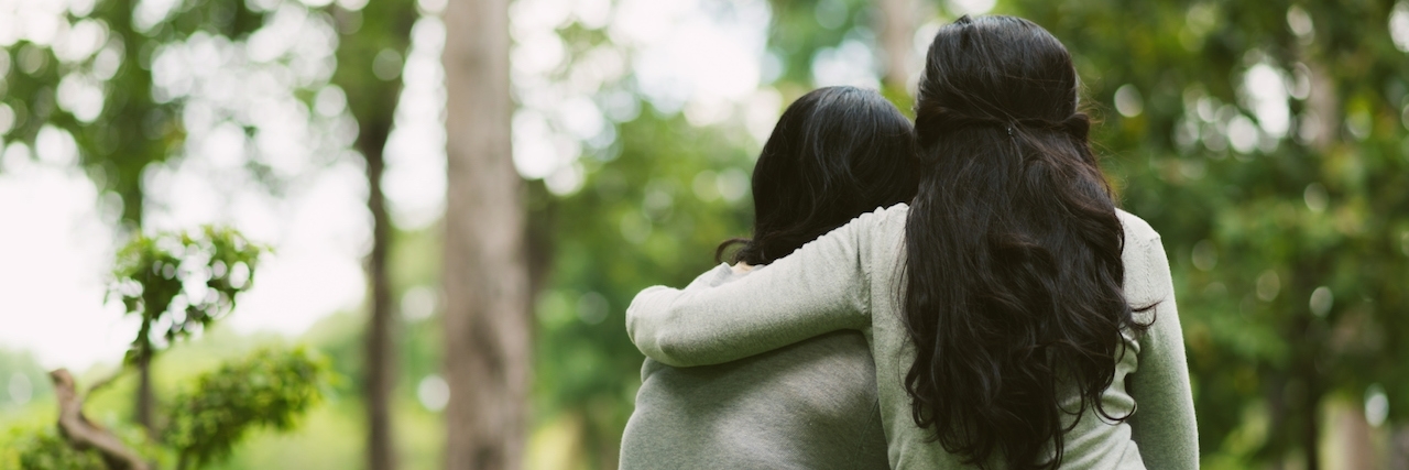 How to Help a Friend With Type 1 Diabetes Rear view of hugging female friends sitting in the park