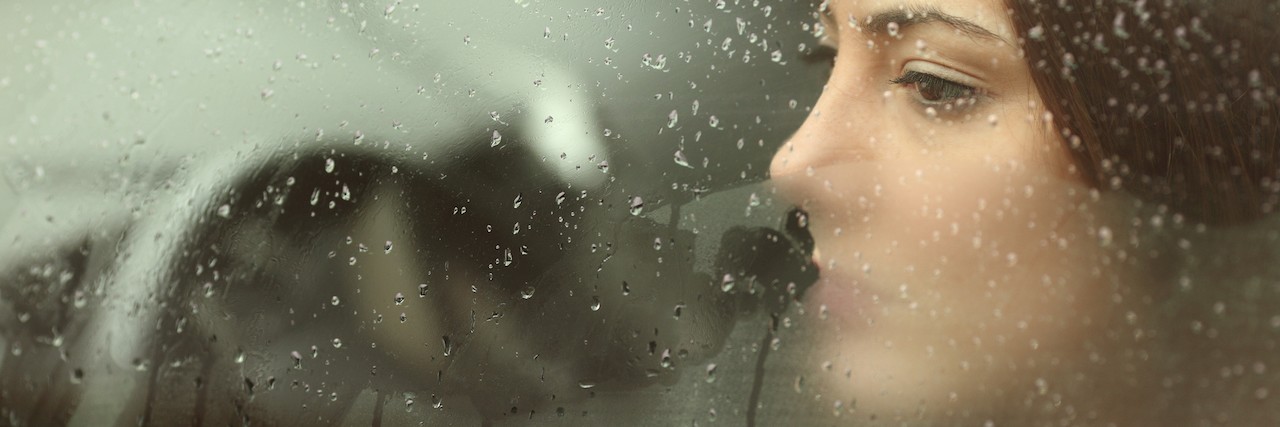 What It's Like to be Suicidal in High School Sad woman or teenager girl looking through a steamy car window