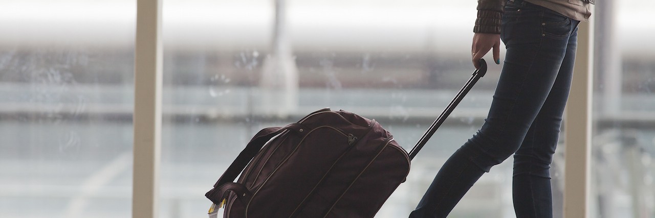 Advice for Traveling With Lyme Disease Woman carries your luggage at the airport terminal