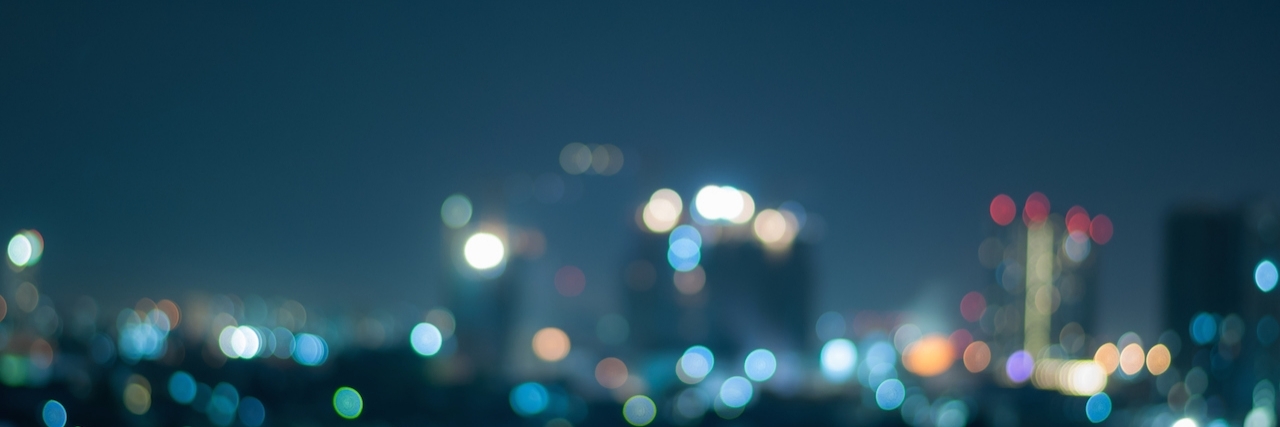 Depression: Feeling Lonely and Tired at Night defocused abstract city night lights background