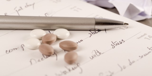 The Questions My Rare Diagnosis Papers Begged Me to Ask Office workplace with book, crumpled paper, pen, on grey desk