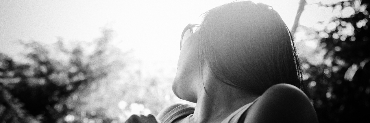 What People Say in the Gray Area of Being Suicidal Young woman sitting and relaxing while enjoying the sun