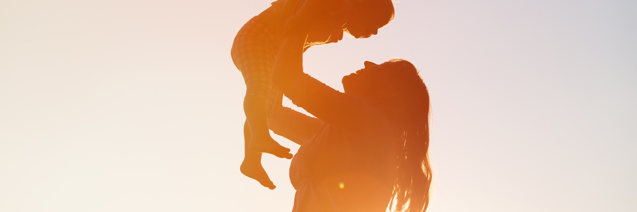 How My Daughter Is Teaching Me to Accept My Chronic Illness mother and little daughter play at sunset sky