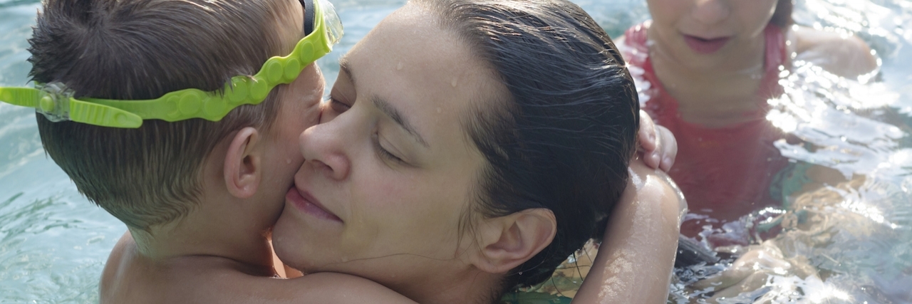 To the Woman at the Pool During My Son's Sensory Overload Meltdown Mother and her children having fun in the swimming pool