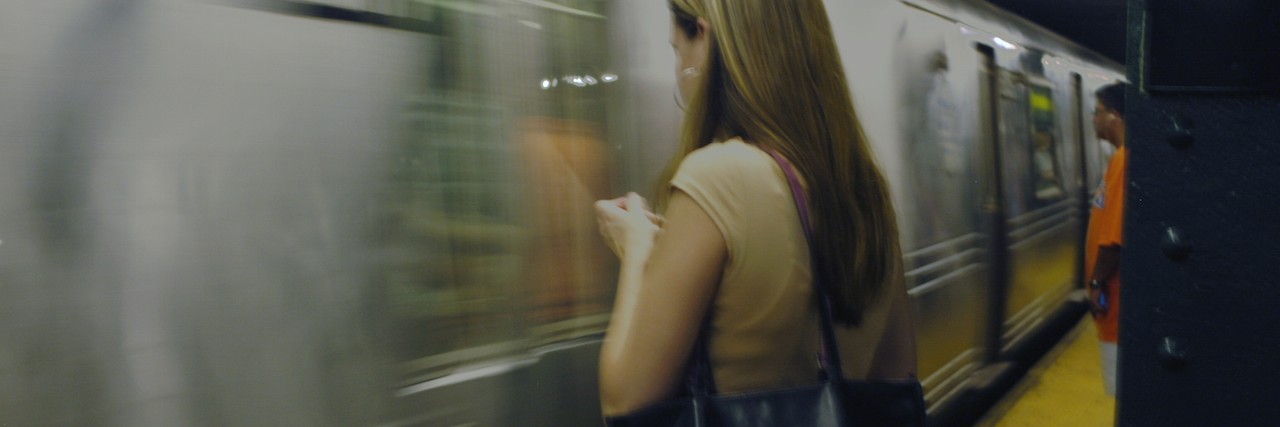 woman waiting for new york city subway