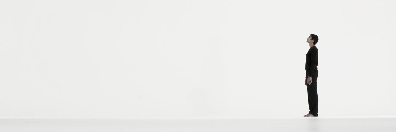 Feeling Lonely and Isolated With a Chronic Illness: You Are Not Alone Man standing in distance against white background, side view