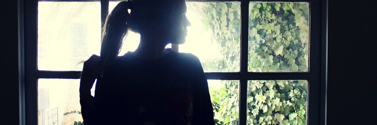 What Friends Should Know About My Agoraphobia lonely woman standing by window