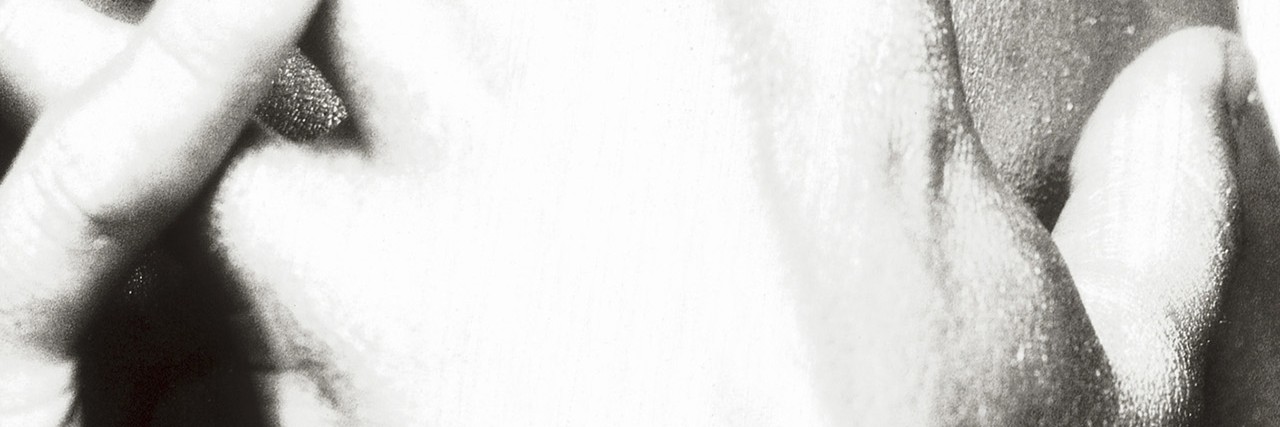 Facing Anxiety While Living With Cerebral Palsy Close-up of a young man covering his face with his hands.