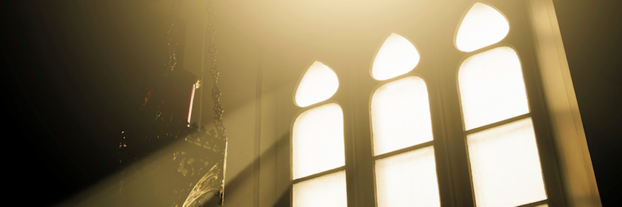 Rays of light through glass in a window in a church