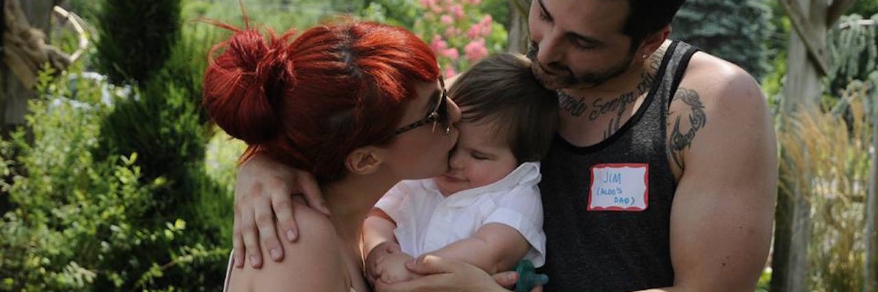 My Son Changed My Perception of People With Disabilities Kris and her husband kissing their son.