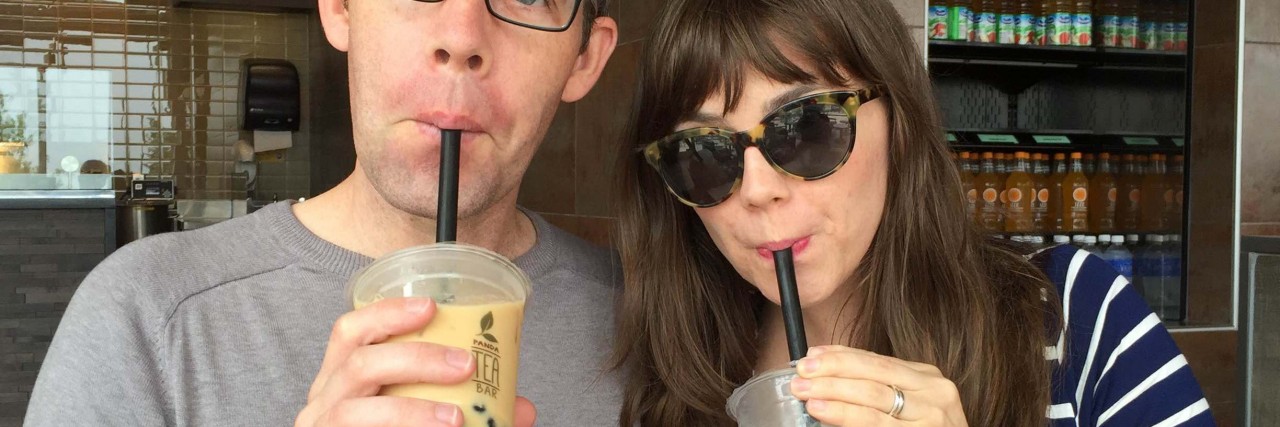 How to Cheer Someone Up Who's Having a Bad Day man and woman sipping cups of tea with straws