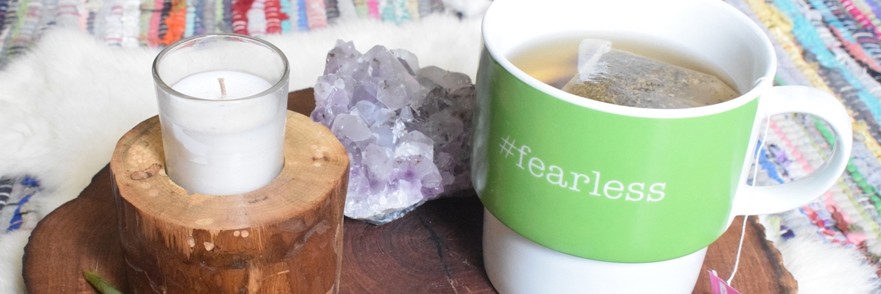 Self-Care Tips for Chronic Illness wooden plate with candle and mug on top
