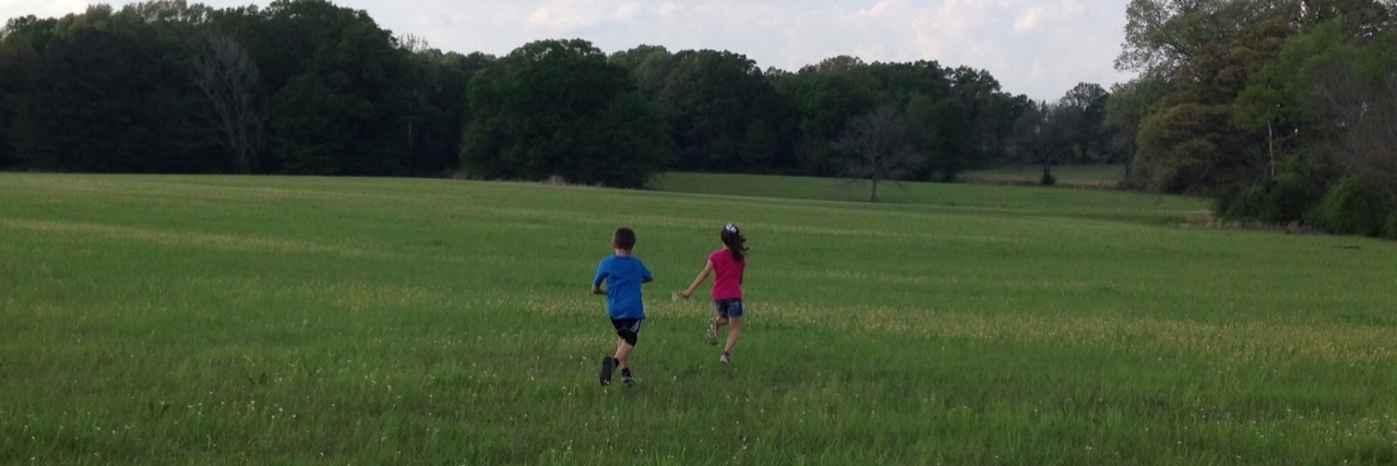 What Kids Learn From Having a Parent With Cancer boy and girl running away on grass
