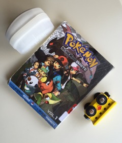 Pokemon book next to a toy truck