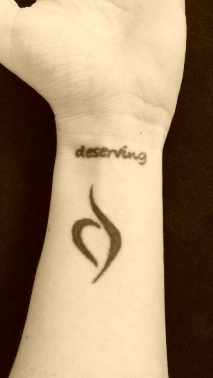 tattoo reads "deserving"