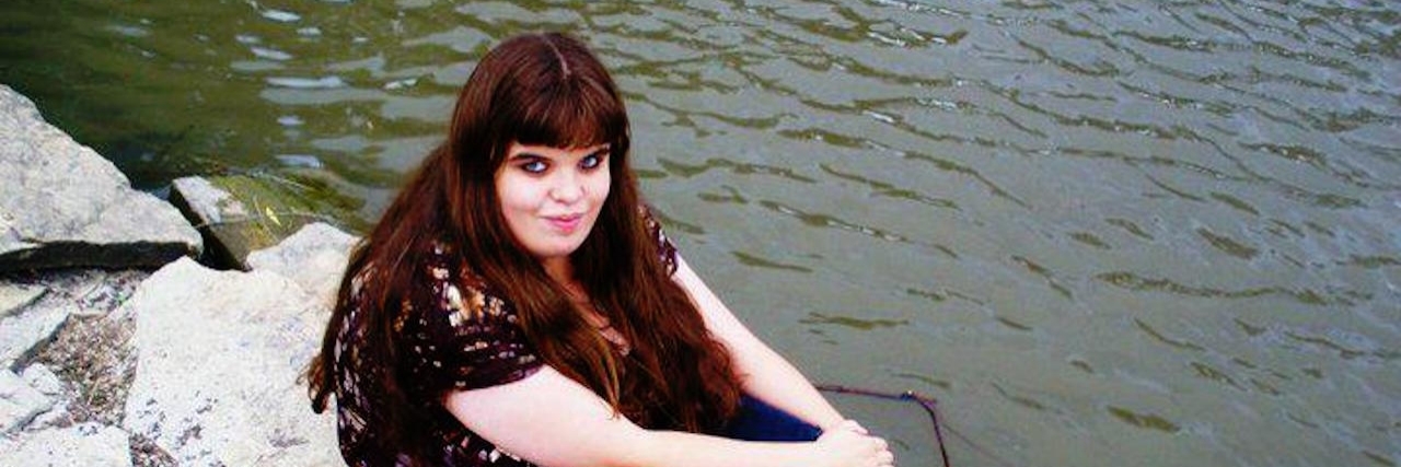 Autismally Beautiful: A Poem woman sitting on rock