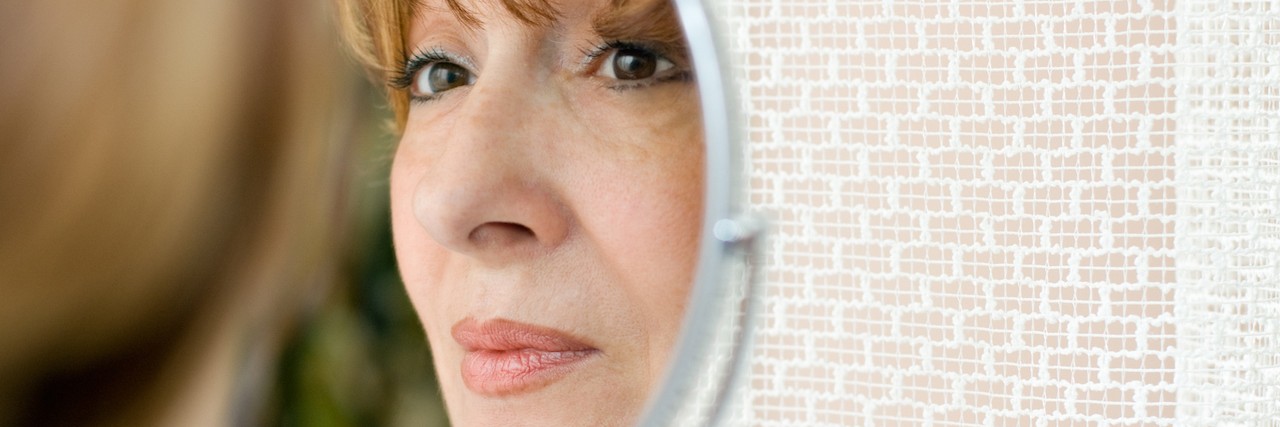 When People Compare Anxiety to Being 'Too Sensitive' Older woman looks at her reflection