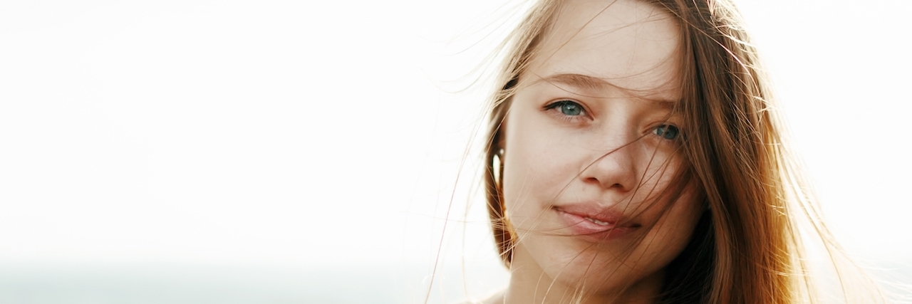 To the People Who Self-Harm: It's Not Worth It Woman with long hair blowing in the wind looking in the camera