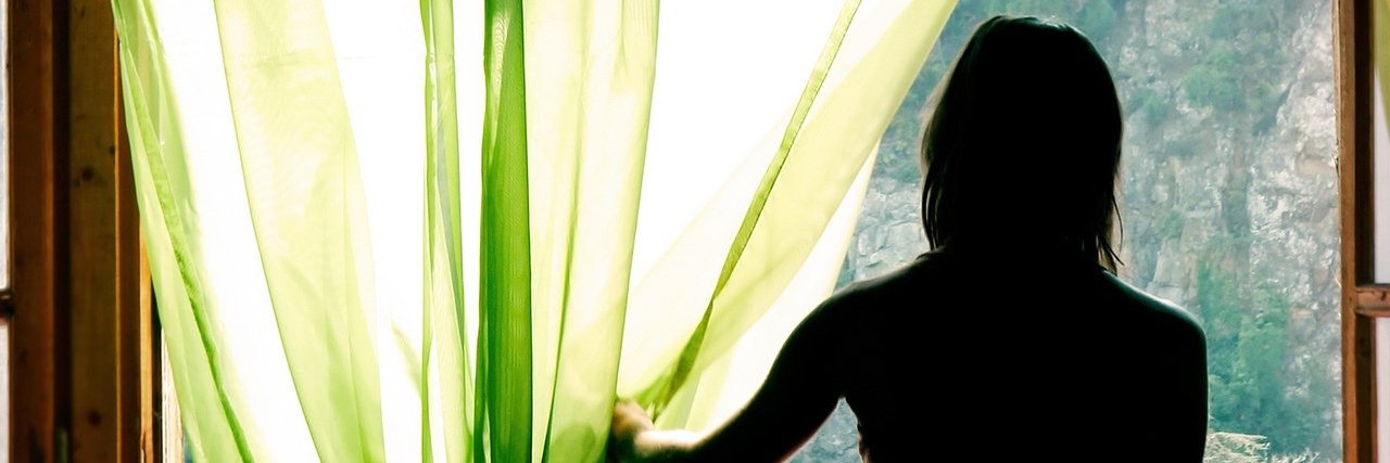 The Indispensable Life Lessons My POTS Has Taught Me young woman looks out a window