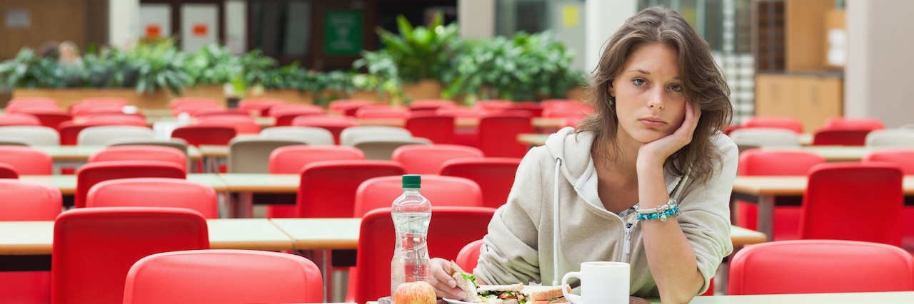 When I Can't Eat in the Office Because of My Eating Disorder Frustrated woman sitting at lunch table