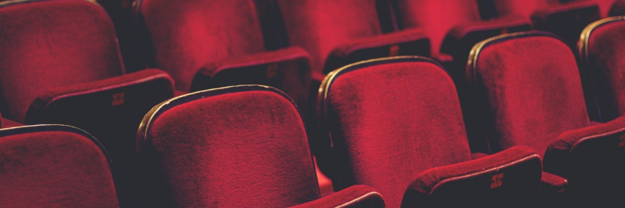 Movie Theaters Offer Sensory-Friendly Screenings for Autistic People Empty comfortable red seats with numbers in cinema