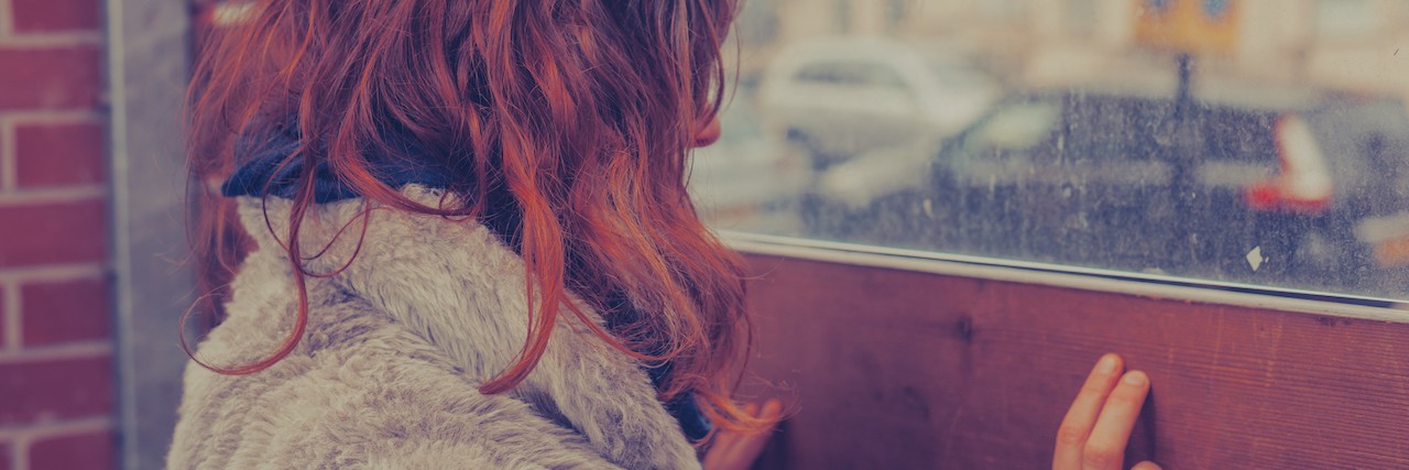 A Letter to My Schizoaffective Disorder Woman looks out side to a rainy street