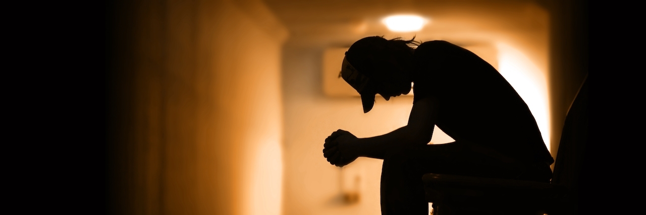 Why We Shouldn't Say 'Commit Suicide' Young man with hands clasped together