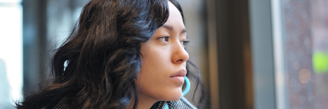 Advice for Anyone Starting Their Eating Disorder Recovery A girl sitting stares out a window