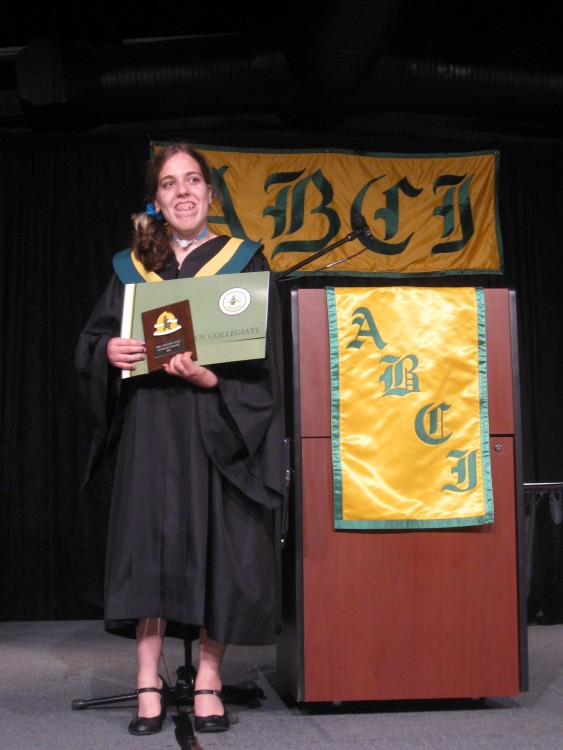 high school graduate at podium with aware