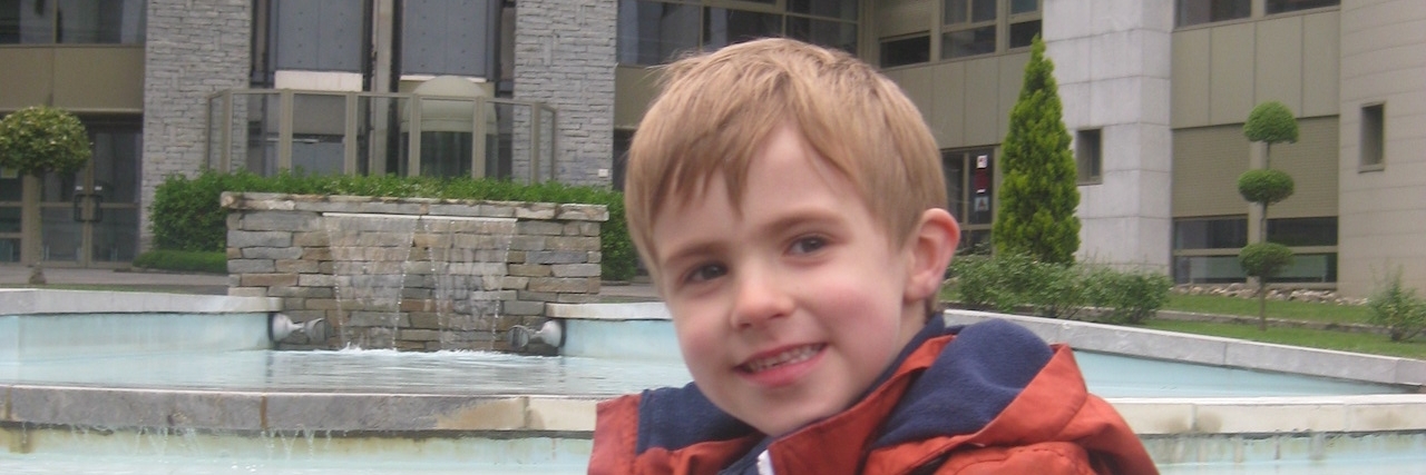 Why I'm Afraid I'll 'Blink' Through My Son's Life With Duchenne Luke smiling holding a teddy bear