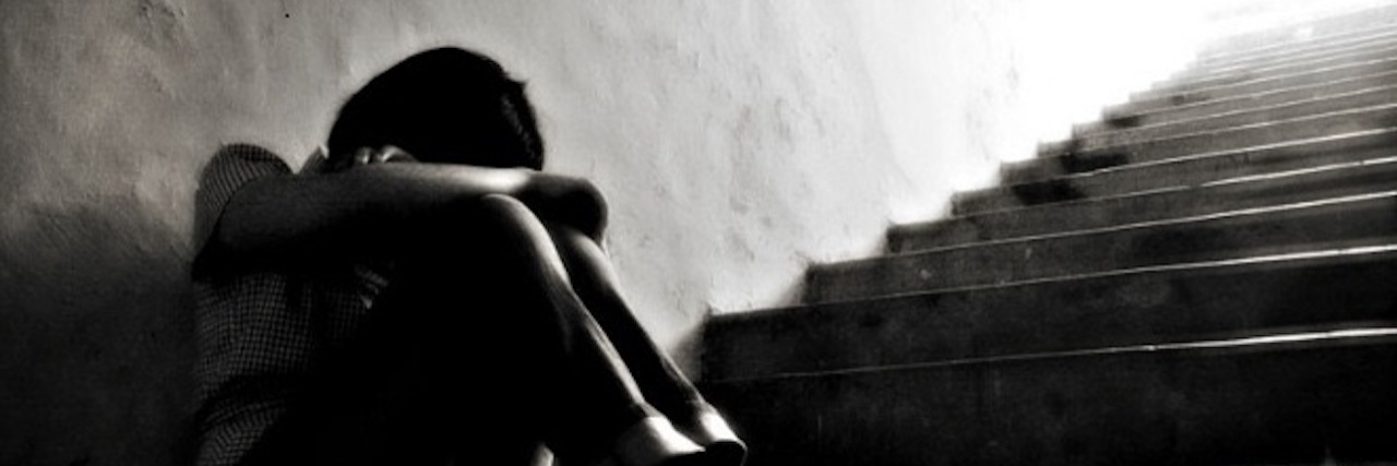 How to Help a Family Member or Friend With Anxiety and Depression woman in dark corner