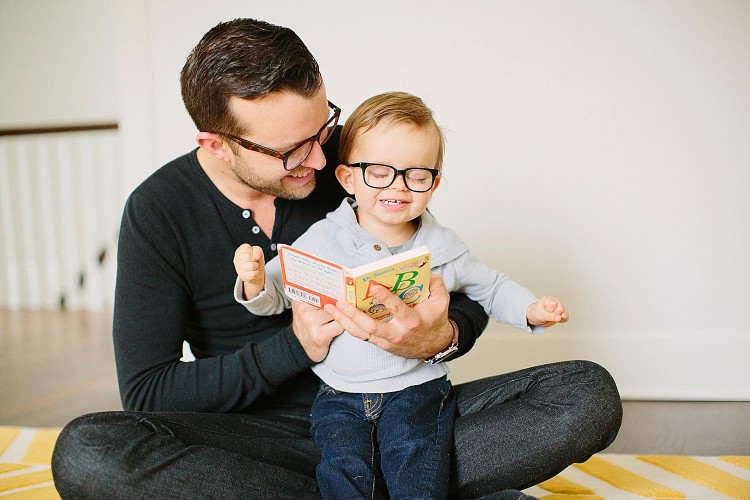 Jonas with his father wearing glasses and smiling