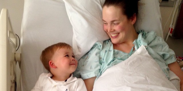 mother in hospital bed lying next to her son