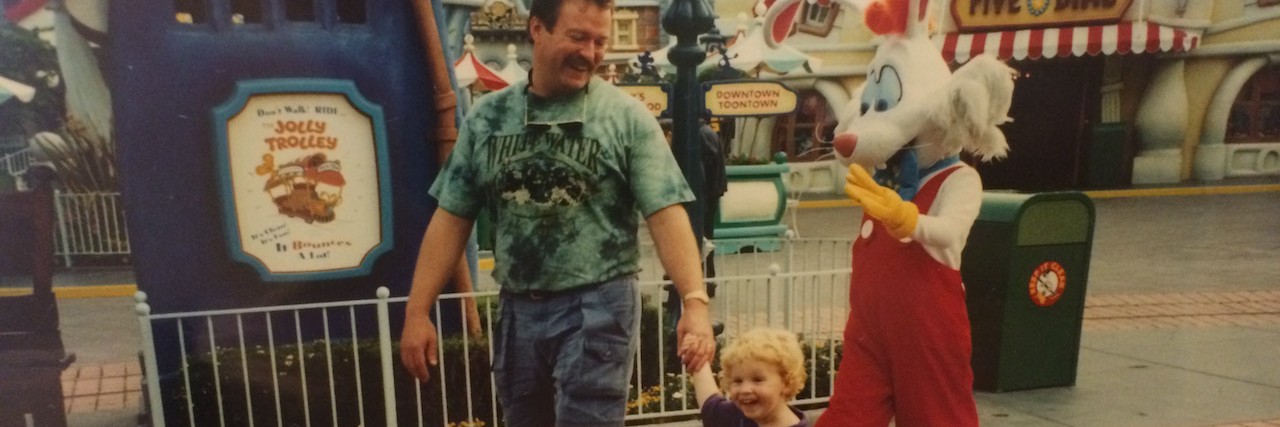What to Say When Your Father Doesn't Accept Your Mental Illness Dad holds daughter's hand as they walk through an amusement park