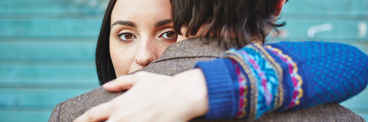 A Letter to my Future Husband About My Depression Woman looking at camera while embracing man who faces opposite direction