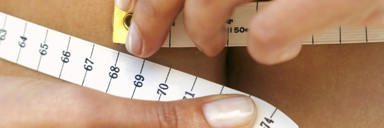 How Bipolar Disorder Affects Body Image Woman measuring waistline