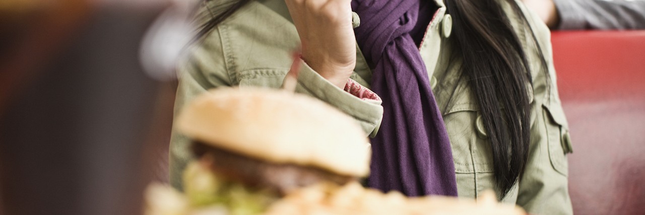 When an Invitation to Lunch Makes a Person With Mental Illness Anxious Woman sitting at diner counter, talking and eating