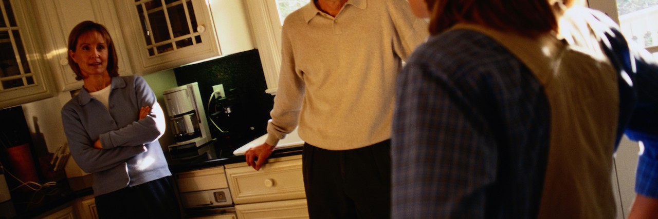 Dear Mom and Dad: From a Teen With Mental Illness Teen girl talks to parents in kitchen