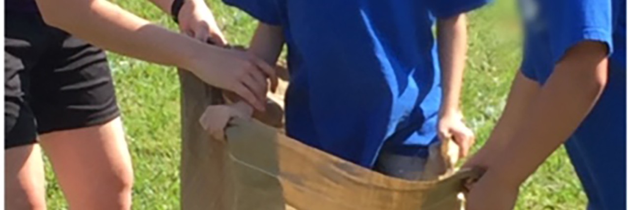 Field Day for My Daughter With Sanfilippo Syndrome Abby in the sack race.