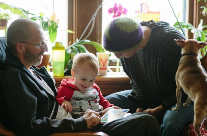 Grandson Jack sits on Ray's lap and listens to a story. Rae, with family dog Eddie says, “Family is the best medicine.”