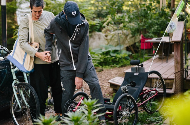 Ray continues to pursue his love of cycling. Here, Rae and Eddie help Ray into his trike “of comfort and freedom,” Rae adds.